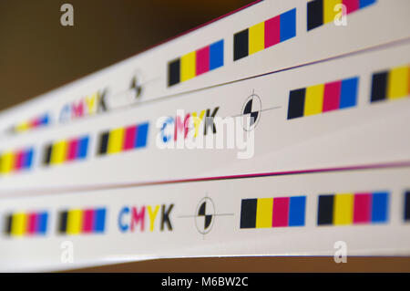 CMYK test printed on white paper. Cyan, magenta, yellow, black and registration mark. Stock Photo