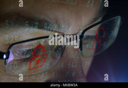 Face of man breaking computer system security. Cyber crime concept. Open red padlock. Stock Photo