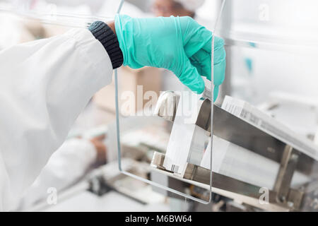 Paper Label Inside Insert Machine Hand placing labels into a label inserting machine Stock Photo - Alamy