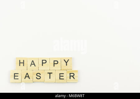 Text wooden blocks spelling the word happy easter on white background Stock Photo
