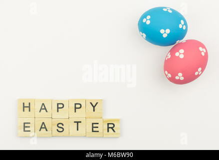 Text wooden blocks spelling the word happy easter on white background Stock Photo
