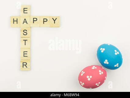 Text wooden blocks spelling the word happy easter on white background Stock Photo