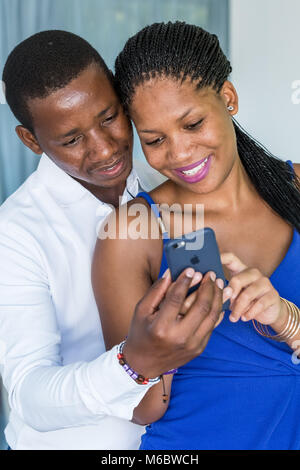 Couple looking at mobile phone. Stock Photo