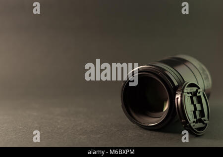 Macro lens and lens cap on grey background Stock Photo