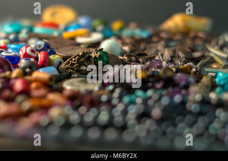 Green gem ring on a pile of decorative accessories Stock Photo