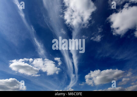 Cirrus clouds and Cumulus humilis clouds in a deep blue sky. Stock Photo