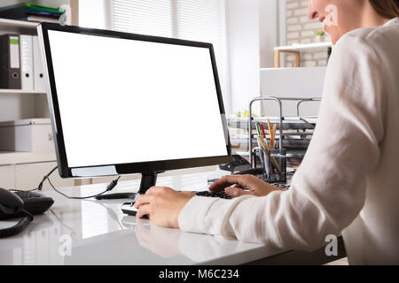 Young Businesswoman Working On Computer With Blank White Screen Stock Photo