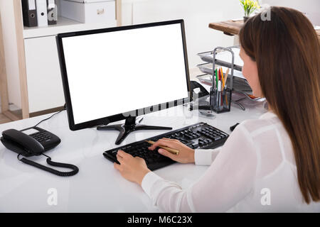 Young Businesswoman Working On Computer With Blank White Screen Stock Photo