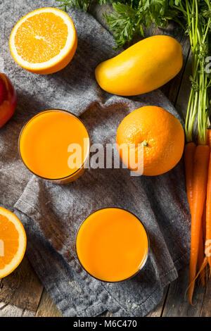 Healthy Organic Orange Carrot Smoothie Juice Drink with Mango and Banana Stock Photo