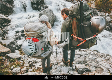 Couple backpackers friends hiking in mountains at river love and Travel Lifestyle wanderlust concept adventure vacations outdoor Stock Photo