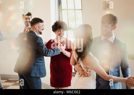First partner dance at a wedding. All of the couples are dancing together along with the bride and groom. Stock Photo