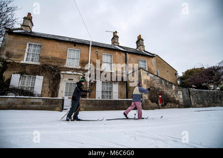 Two man cross county ski through the village of Batheaston near Bath in Somerset after heavy snowfall. Beast from the East, Storm Emma. Stock Photo