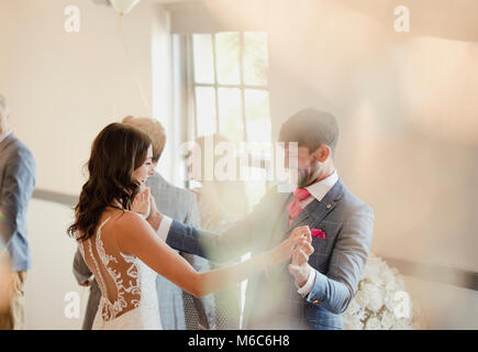 Bride and groom are enjoying dancing together on their wedding day. Stock Photo
