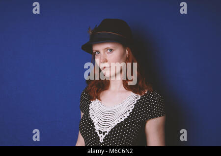 young woman wearing vintage dress and hat Stock Photo