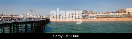 BRIGHTON, UK - JUN 5, 2013: Beachfront panoramic view with the Ferris Wheel promenade and shingle beach pictured from the Brighton Palace Pier on a su Stock Photo