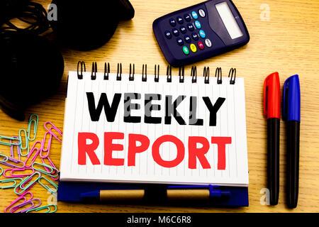 Conceptual hand writing text caption showing Weekly Report. Business concept for Analyzing Performance  written on notebook book on the background in  Stock Photo