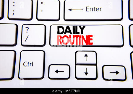 Hand writing text caption inspiration showing Daily Routine. Business concept for Habitual Lifestyle written on white keyboard key with copy space. To Stock Photo