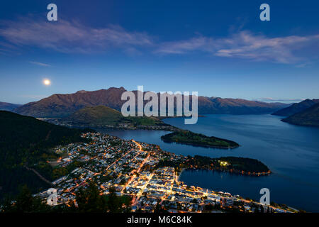 A full moon rises over Lake Wakatipu, Queenstown, New Zealand Stock Photo