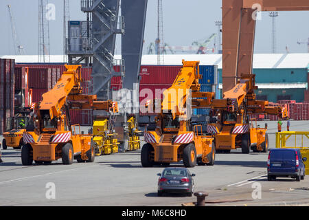 ANTWERP, BELGIUM - JUL 9, 2013: Reach stackers in the Port of Antwerp. Stock Photo