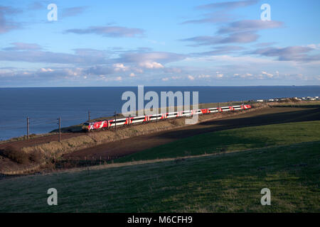 A Virgin Trains east coast class 91 + Intercity 225 train passes Marshall meadows, (north of Berwick upon Tweed) with the 1030 Kings Cross - Edinburgh Stock Photo