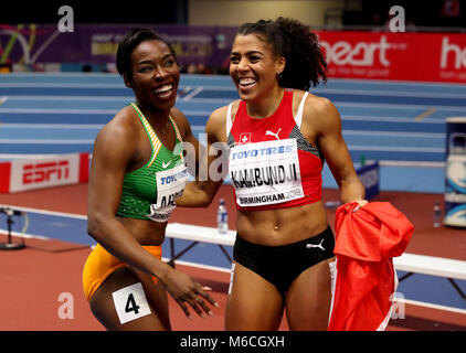 Ivory Coast's Murielle Ahoure (left) celebrates winning gold alongside Switzerland's bronze medal winner Mujinga Kambundji (right) in the Women's 60m final during day two of the 2018 IAAF Indoor World Championships at The Arena Birmingham. Stock Photo