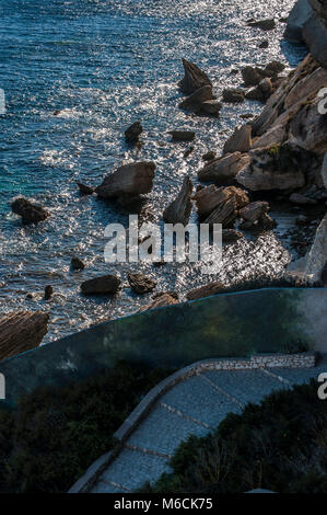 Corsica: the footpath along the beach beside the breathtaking white limestone cliffs of Bonifacio in front of the Strait of Bonifacio Stock Photo
