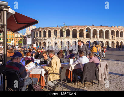 Verona, Italy - Piazza Bra, showing the Roman Arena and people sitting at restaurant cafes Stock Photo