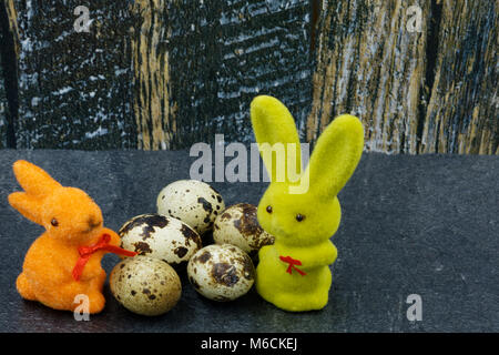 Easter decoration, two bunnies and eggs on a rustic vintage background.Horizontal view. Stock Photo