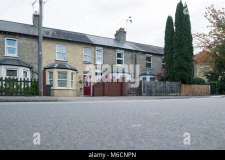 a typical english terraced row of houses in Cambridgeshire with a bay window, double glazing and a block paving driveway. Stock Photo