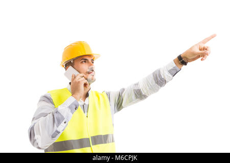 Visionary and successful architect or engineer talking on the phone and showing pointing finger up Stock Photo
