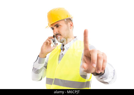 Busy architect or contractor showing wait hold gesture while talking on the phone Stock Photo