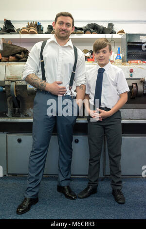a father and son stand in their shop which repairs and meds shoes and cuts keys on the hight street Stock Photo