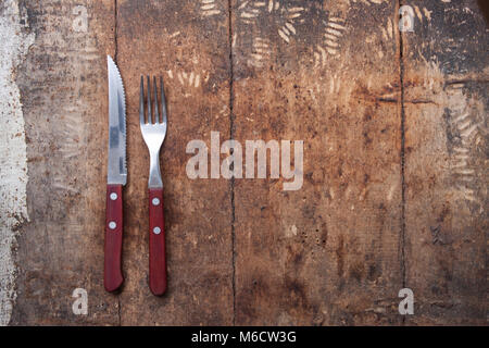 knife and fork on wooden background. Cutlery on wooden.. Stock Photo