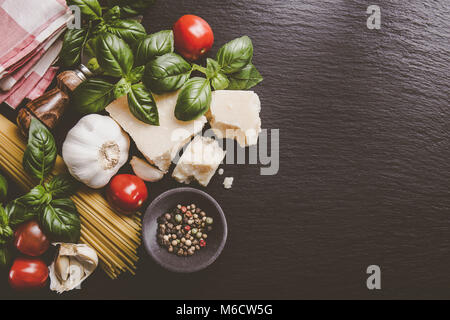 Top view of different vegetables and products for pasta making on rough table. Stock Photo