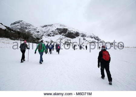 Edinburgh, United Kingdom. 2nd March, 2018. Winter snowfall affecting Arthur's Seat and Holyrood Park. A group of walkers heading out on an ascent of Arthur's Seat which can be seen in the background. Credit: Craig Brown/Alamy Live News. Stock Photo