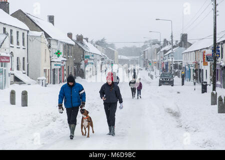Celbridge, Kildare, Ireland. 02 Mar 2018: Main street in Celbridge covered in snow in the aftermath of the cold wave bugged 'The Beast from The East' followed by Storm Emma. People out walking on the covered in snow road in Celbridge town. Winter scenery. Stock Photo