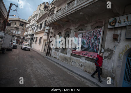 Homs, Syria. 31st Oct, 2017. A girl walks by a picture of Syrian President Bashar al Assad in Homs, formerly known as the 'capital of the revolution' before opposition areas fell in 2014.The city of Homs which is located in the center of Syria was once a anti Assad government real forces' strong hold, It was under the rebel's hand from 2011 until 2014. Credit: S Hayden 010318 20.jpg/SOPA Images/ZUMA Wire/Alamy Live News