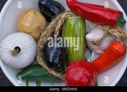 Ceramic fruits and vegetables in a white bowl Stock Photo