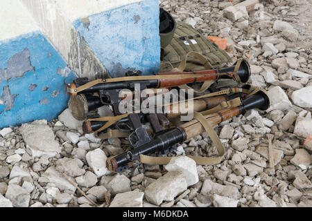 RPG-7 grenade launchers on the rocks in the destroyed building Stock Photo