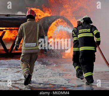 Members of the Slovakian Air Force, (right), learn how to put out major aircraft fires for the first time in the UK at the RAF Manston Defence Fire Training & Development Centre in Ramsgate, Kent. Stock Photo