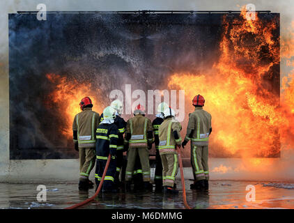 Members of the Slovakian Air Force, (in dark blue), learn how to put out major aircraft fires for the first time in the UK at the RAF Manston Defence Fire Training & Development Centre in Ramsgate, Kent. Stock Photo