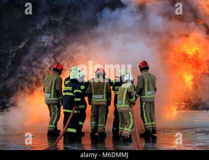 Members of the Slovakian Air Force, (in dark blue), learn how to put out major aircraft fires for the first time in the UK at the RAF Manston Defence Fire Training & Development Centre in Ramsgate, Kent. Stock Photo