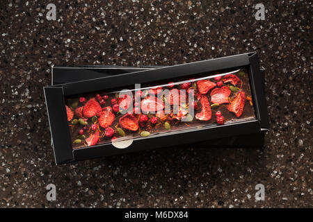 Handmade chocolate with dried strawberries, cranberry and pumpkin seed Stock Photo