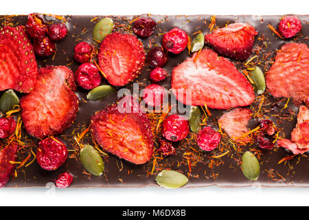 Handmade chocolate bars with dried cranberries, strawberries, nuts. Dark and milk chocolate mix, assortment. Stock Photo