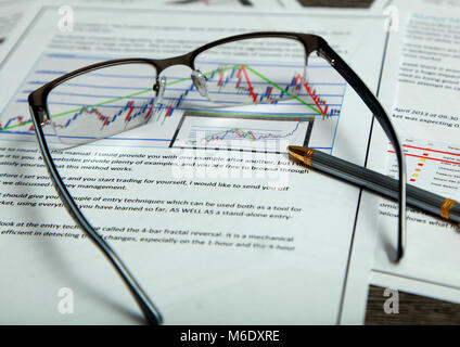 Close-up view shows the documents with the schedule. They lie on the table with glasses and pen. Stock Photo