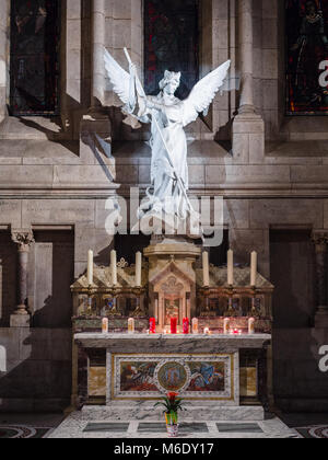 Paris, France - January 5, 2018: Statue of an angel in white stone inside the Basilica of the Sacred Heart, Paris. Stock Photo