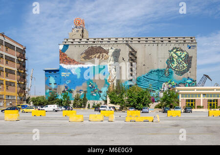 Port of Piraeus, Greece - Mai 30, 2017: Wall painting on one of the old  silo and dry docks  buildings in the industrial area of Silos Ietioneias Coas Stock Photo