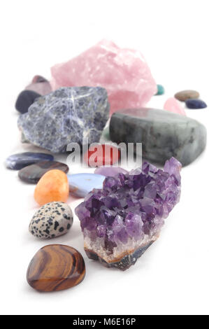 composition of various crystals on white background. Various as kinds, shapes, sizes, and processes. Focus on the closest ones. Stock Photo