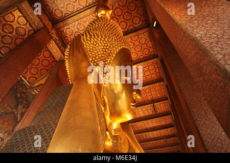 Reclining Gold Buddha statue with close up on the face. Wat Pho, Bangkok, Thailand, Asia. Stock Photo