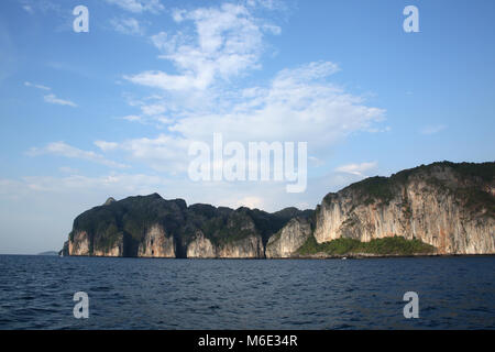 Rugged cliff lined coastline of Koh Phi Phi from the sea, Krabi province, Thailand. Stock Photo